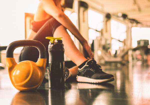 Close-up-kettlebells-with-woman-exercise-workout-gym-fitness-breaking-relax-after-sport