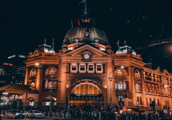 Flinders Station in Melbourne at night with lights.